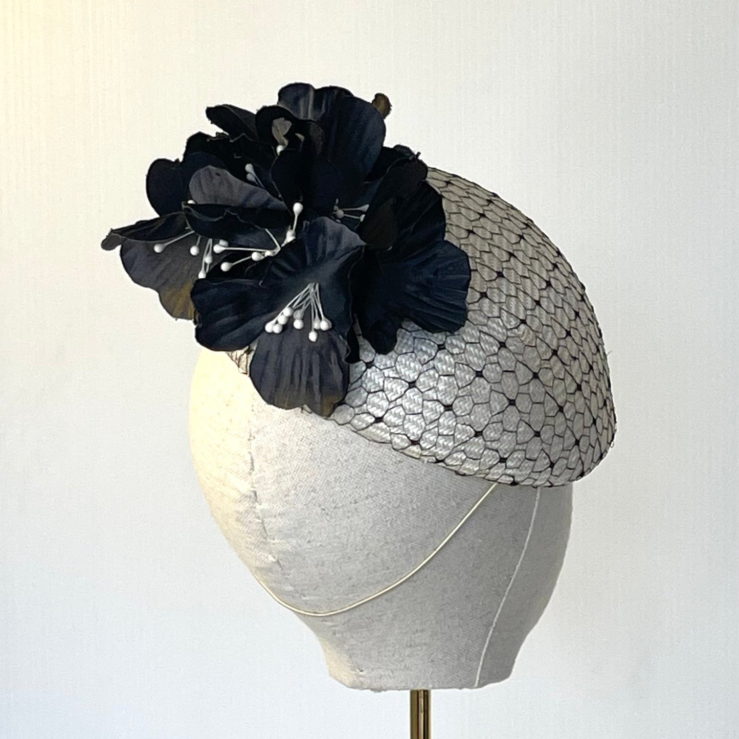 Ivory beret overlaid with vintage black veiling.