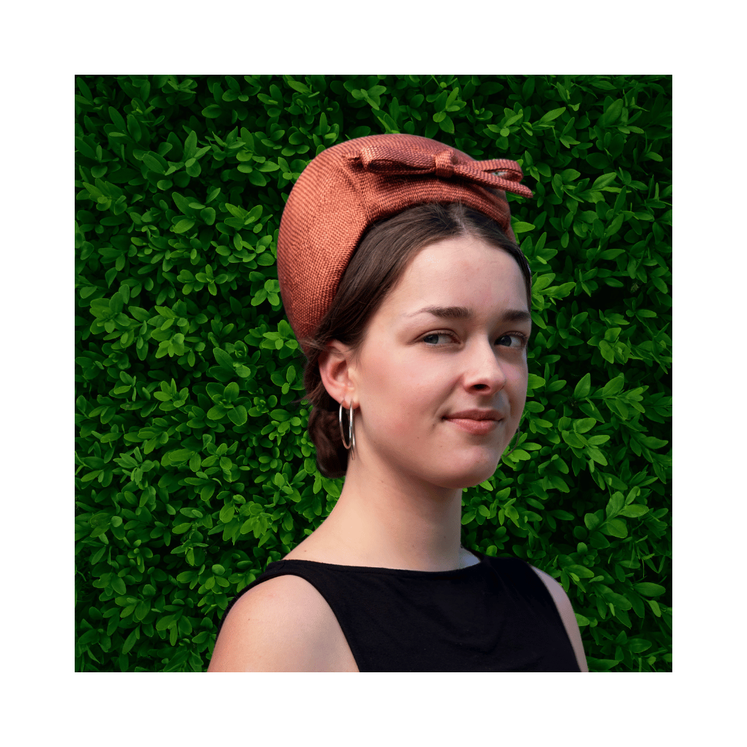 Model wearing a bronze turban by Jo Ramsay Millinery