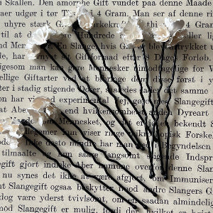 Small and delicate fabric blooms - baby's breath on long black hairpins.